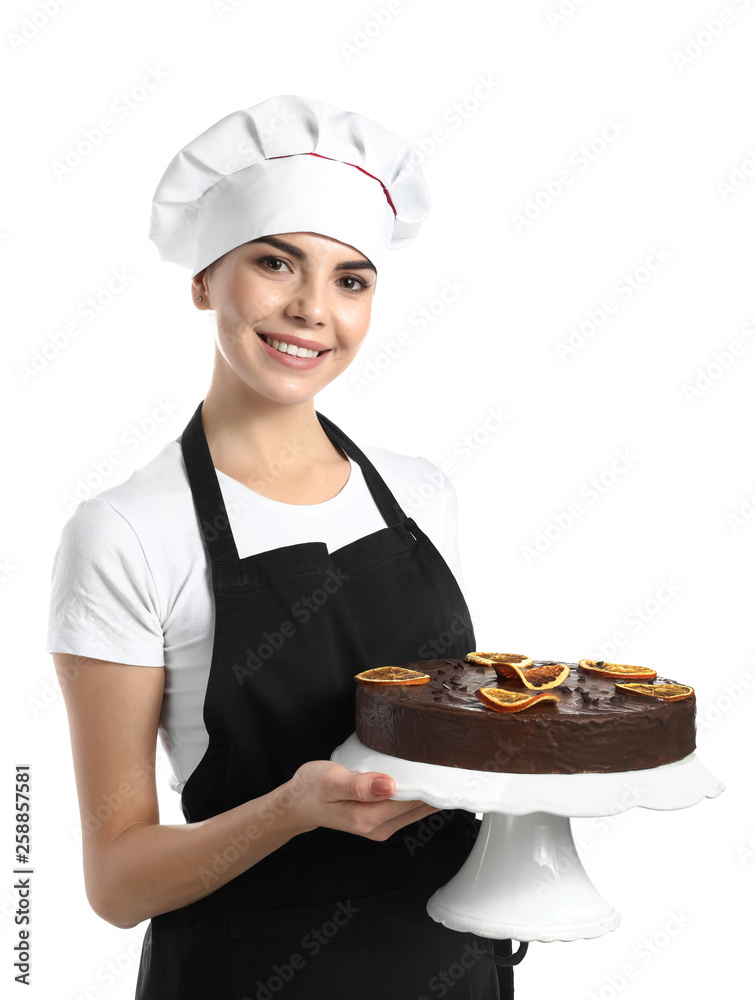 Young female confectioner with tasty cake on white background