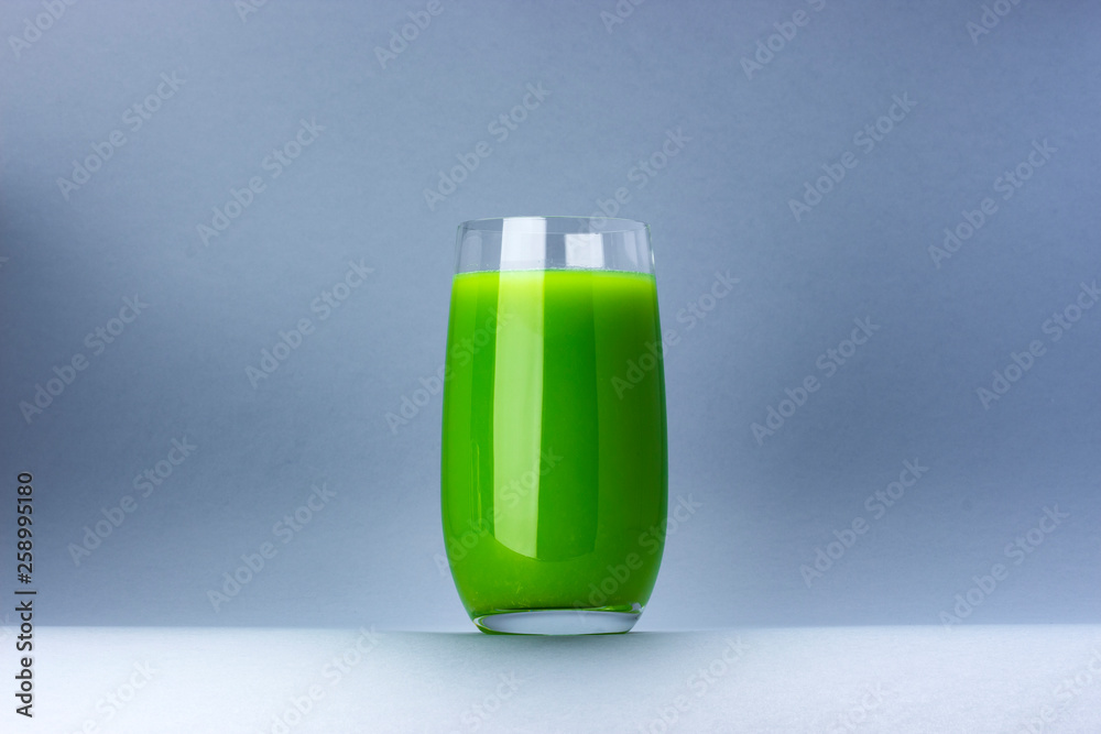 Glass of green juice isolated on white background with copy space for text, fresh apple and celery c