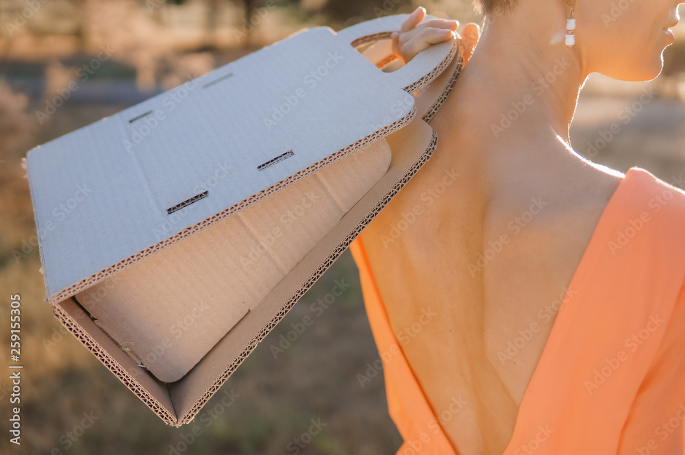 Woman shopping with recycled bag, outdoor shot on the street