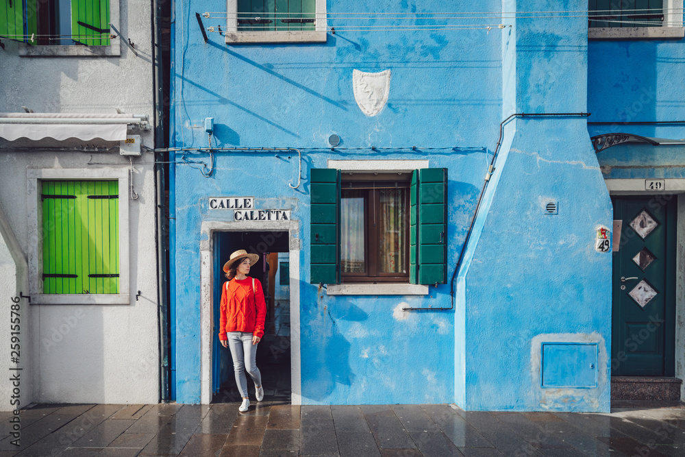 Attractive girl in a red sweater in Burano