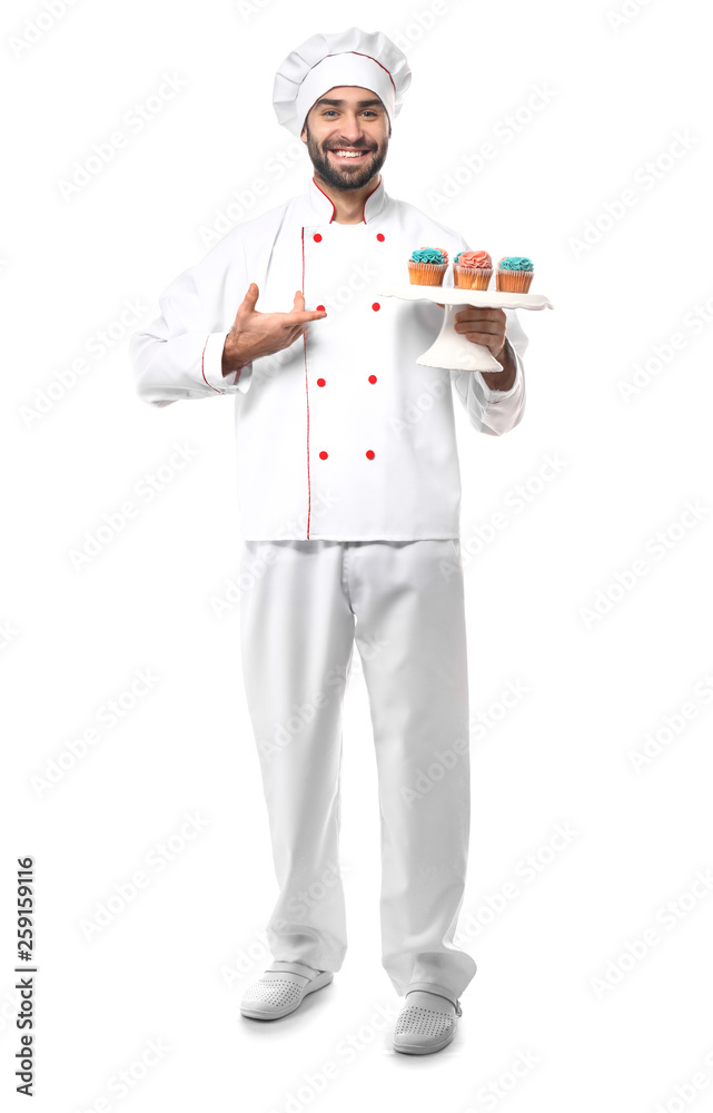 Male confectioner with tasty dessert on white background