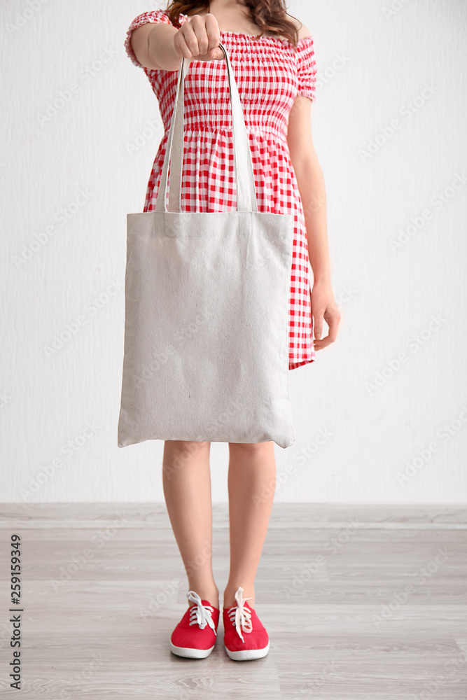 Young woman with eco bag indoors