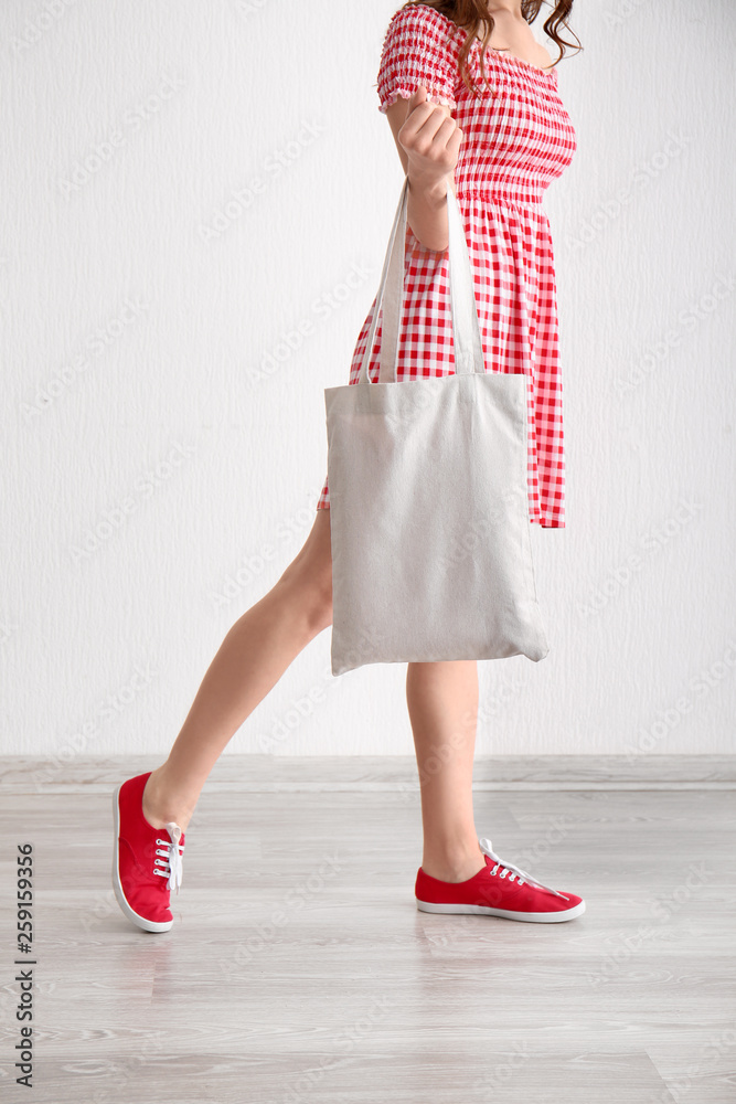 Young woman with eco bag indoors