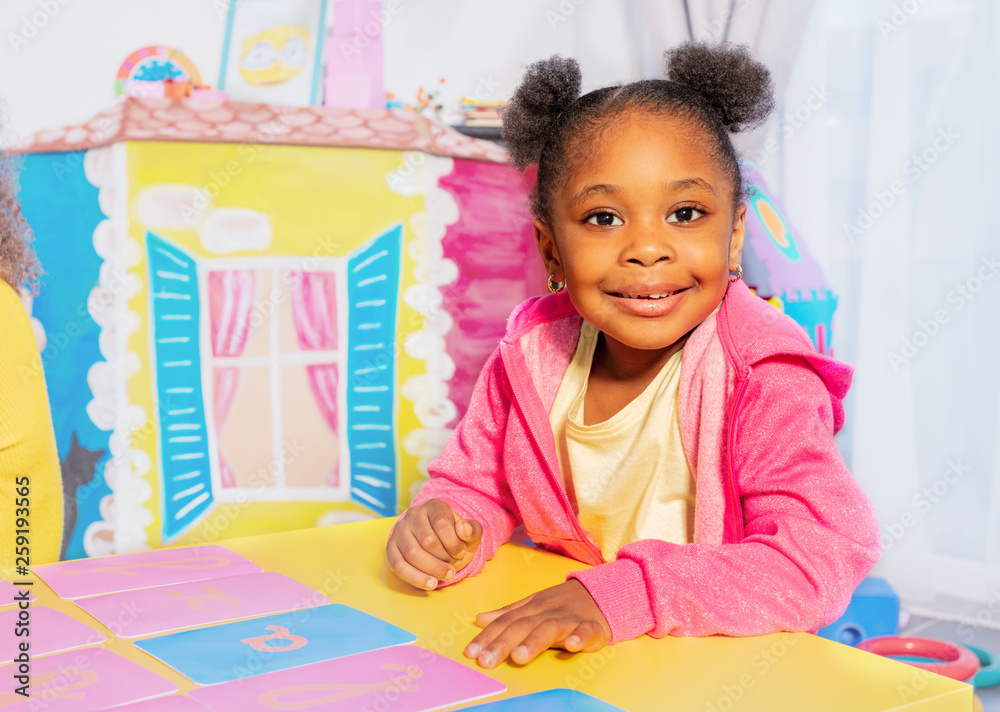 Little girl learn cursive letters in nursery class