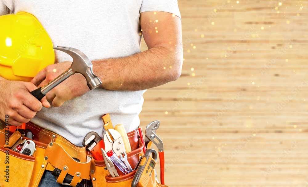 Worker with a tool belt. Isolated over