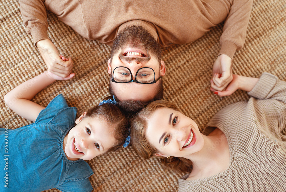 happy family mother father and child daughter laughing   at home