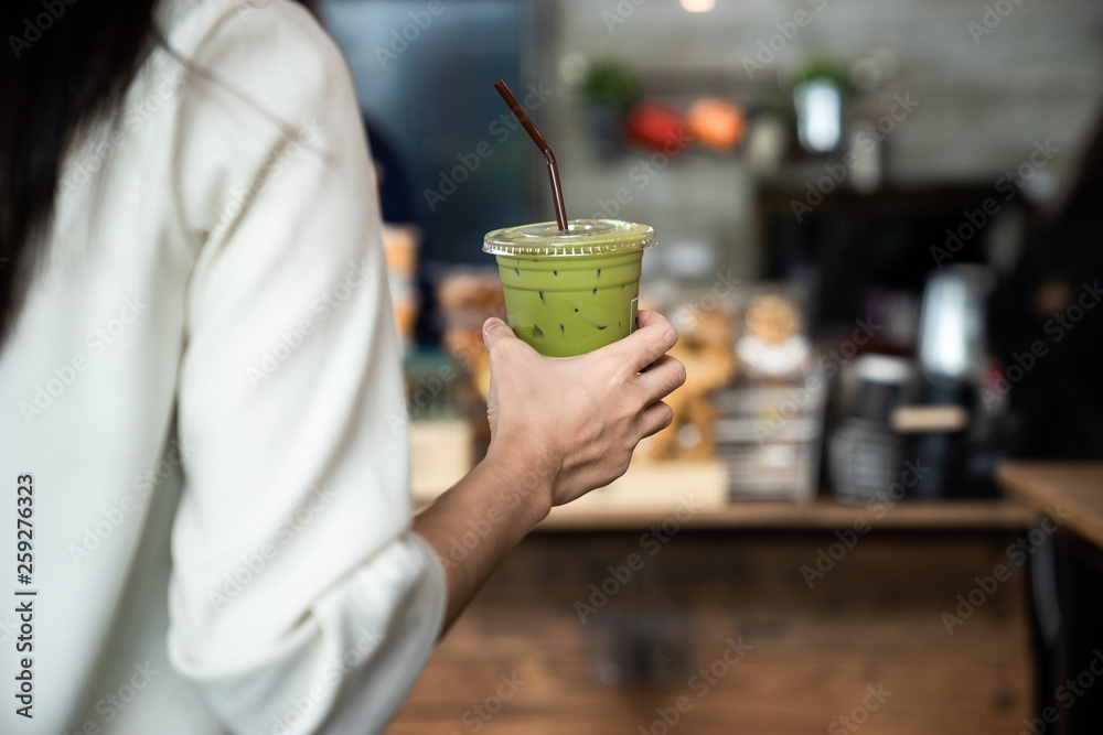 An Asian girl is freelancer woman, she is working by using the laptop computer and drinking a cup of