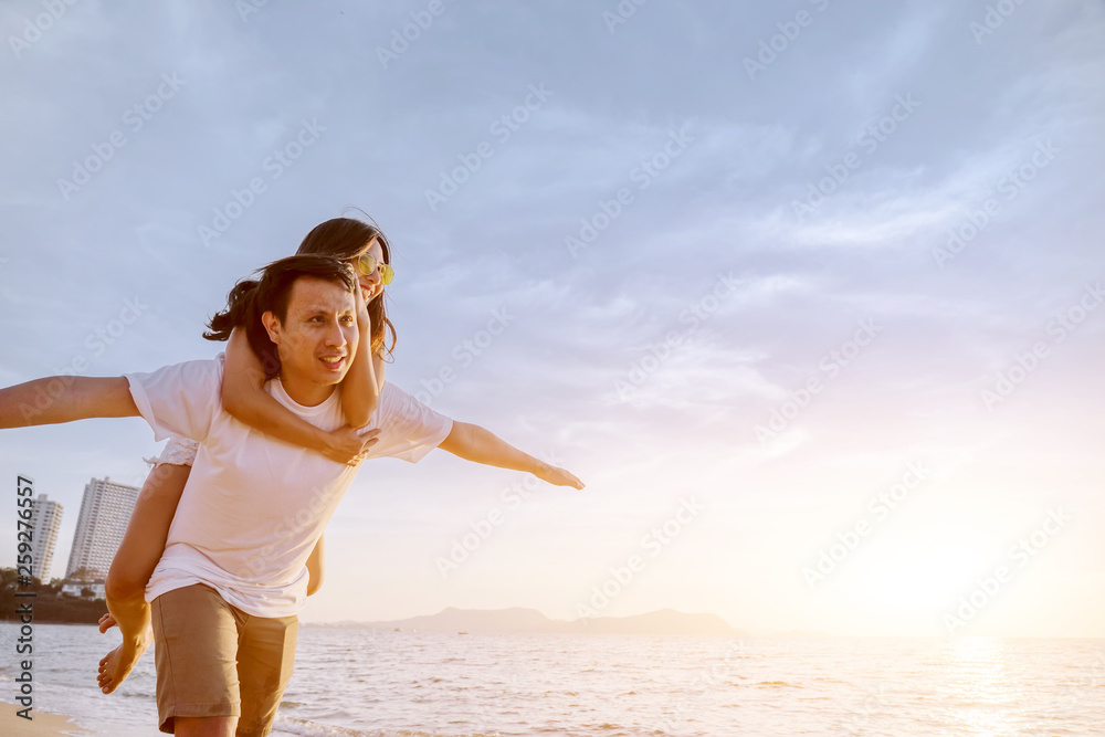 Asian couple are happy with love on the beach at summer weekend holiday.