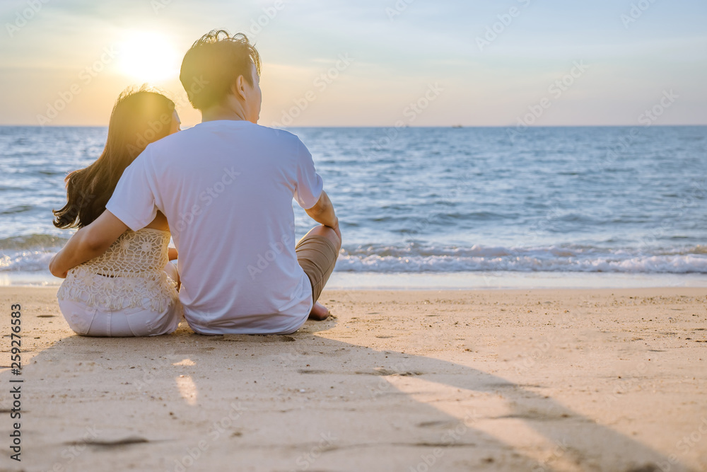 Asian couple are happy with love on the beach at summer weekend holiday.