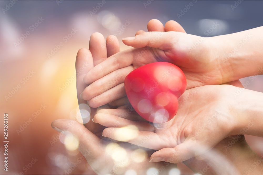 Man and woman holding red heart