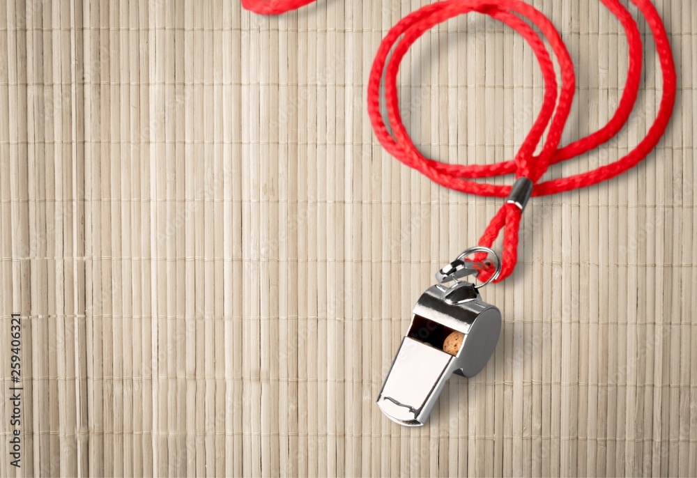 Sports whistle with a lace. It is isolated on a white background