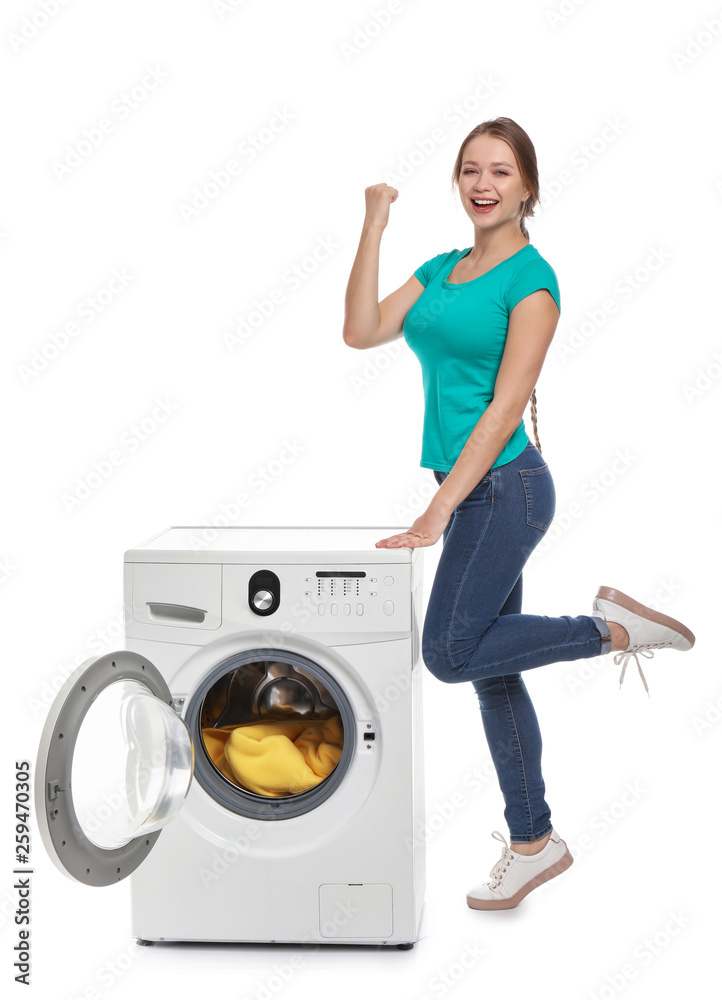 Happy young woman with washing machine on white background