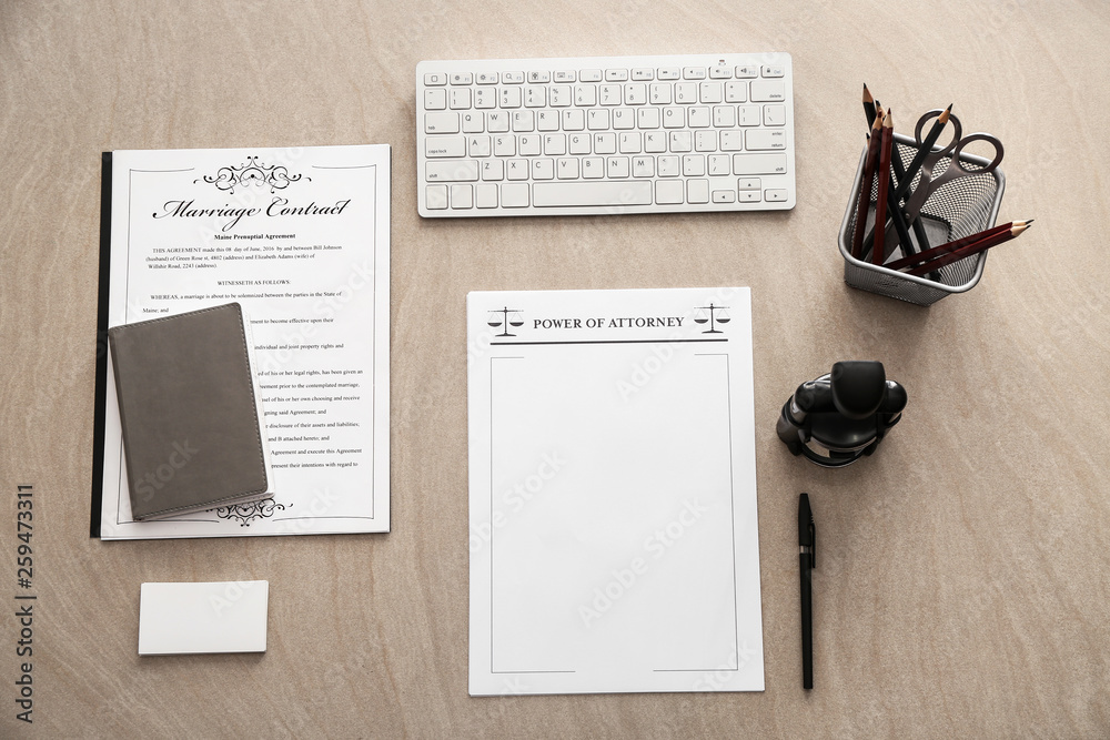 Documents, computer keyboard, stationery and stamp on table of notary public