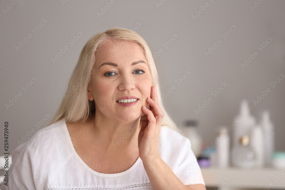 Mature woman with healthy skin at home