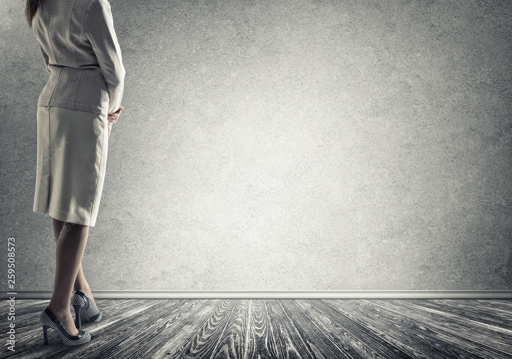 Businesswoman looking at wall