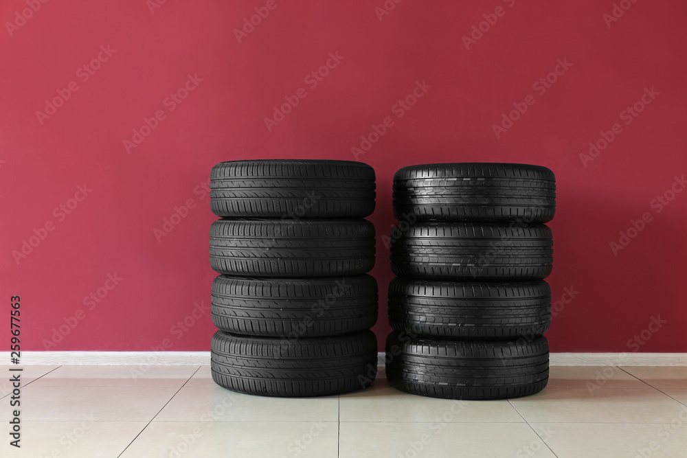 Car tires near color wall