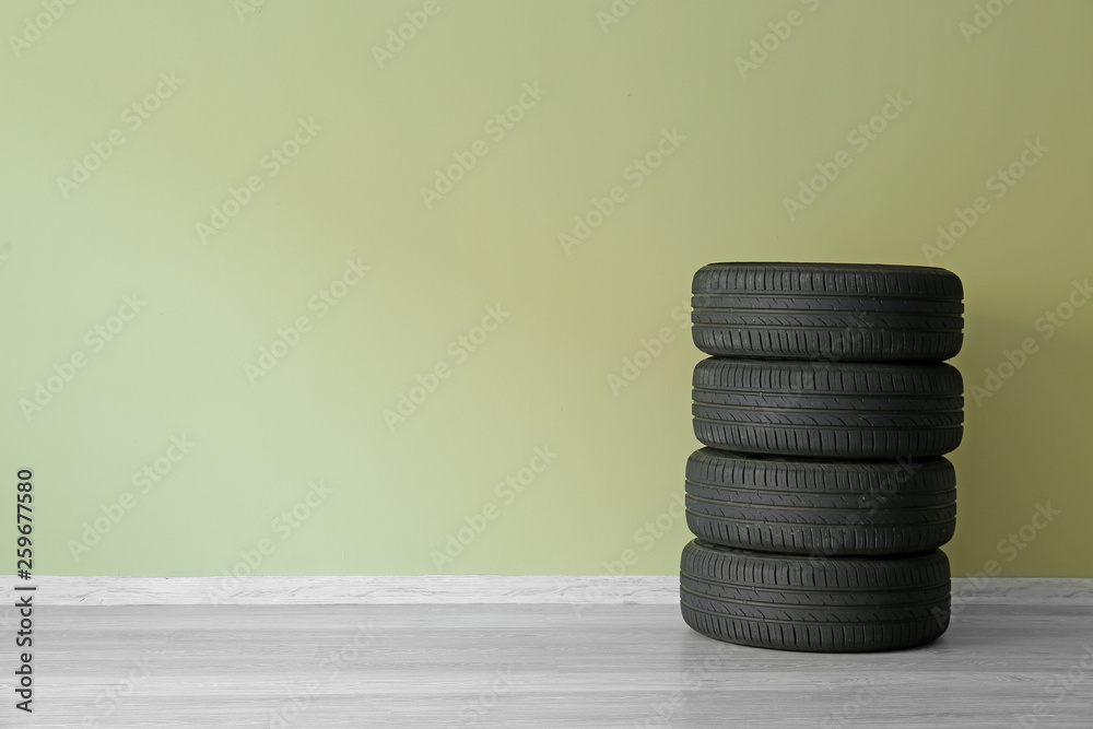 Car tires near color wall