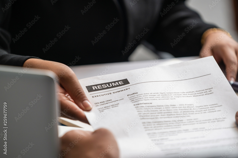 Close up view of employee candidate hands CV resume document to the interviewer HR human resources d