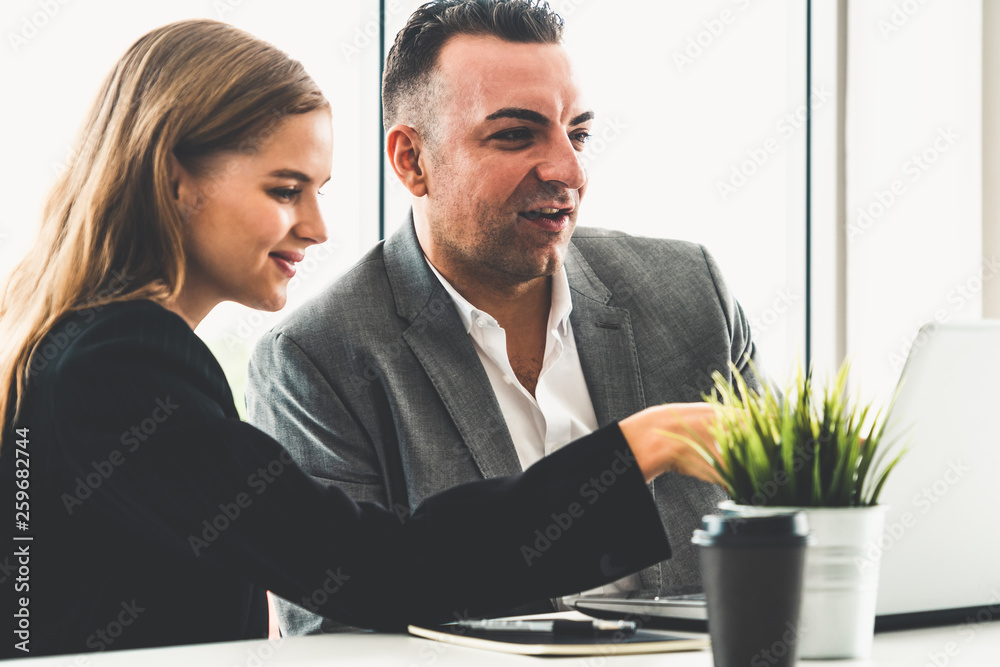 Businessman executive is in meeting discussion with a businesswoman worker in modern workplace offic