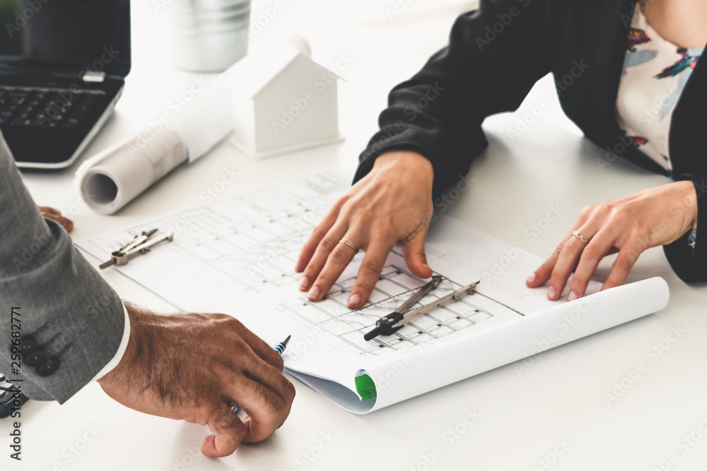 Architect and engineer working with construction drawing project on table in office. Architecture an