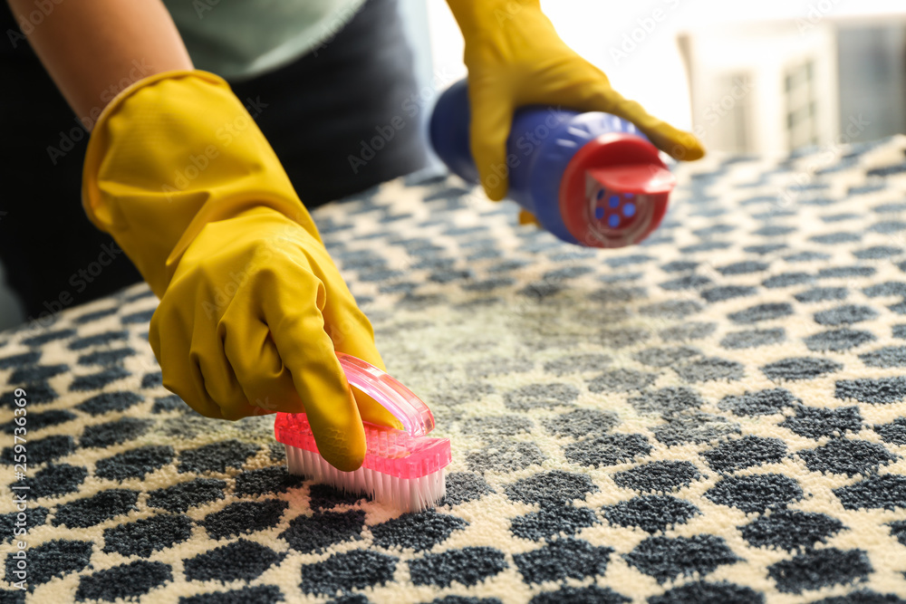 Woman cleaning carpet