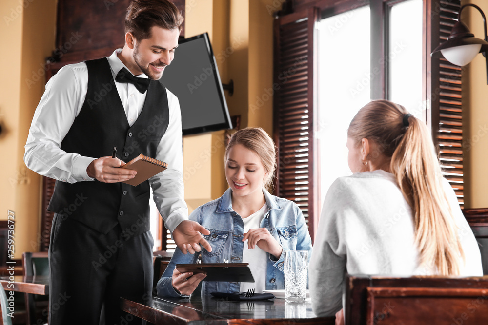 Waiter taking order in restaurant