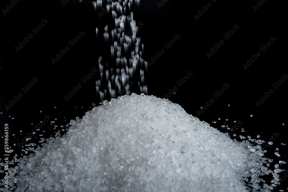 Coarse sea salt on black background