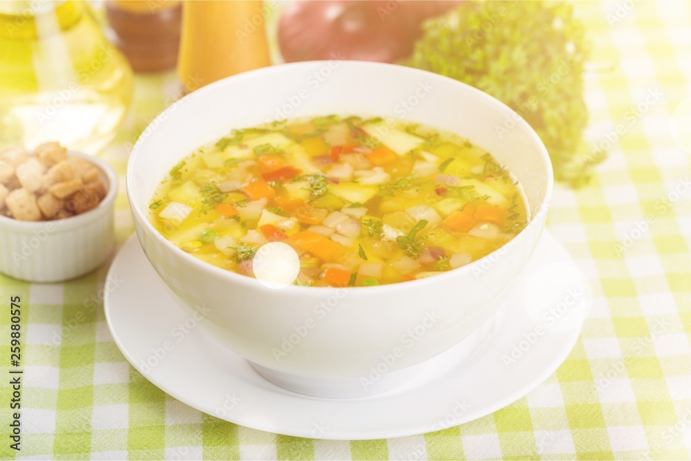 Vegetable soup on dinner tablecloth