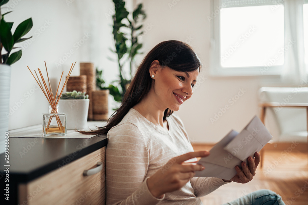 Charming woman receiving a letter.