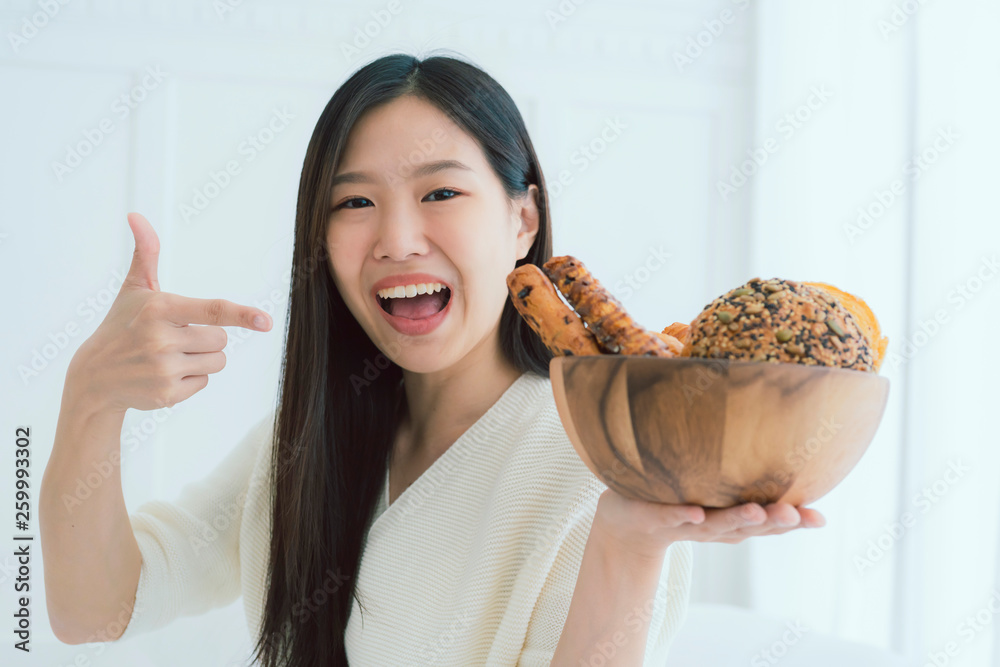 healthy ideas concept portrait of beautiful attractive asian woman hand hold bowl of bread with happ