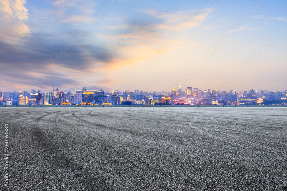 Asphalt race track ground and beautiful city scenery in Hangzhou at night