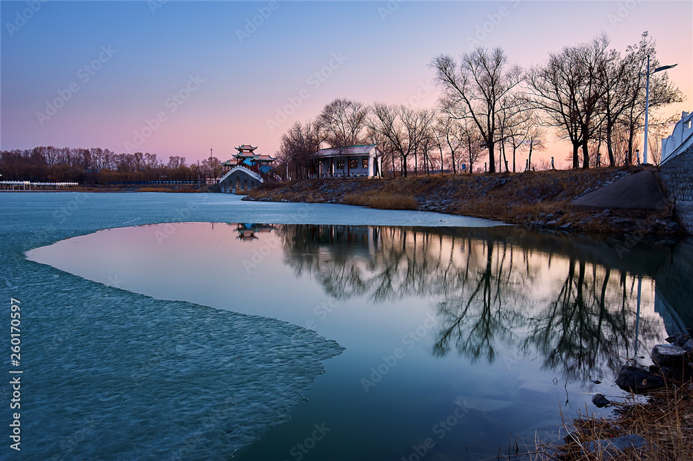 The ice and snow was melting in spring in the park.