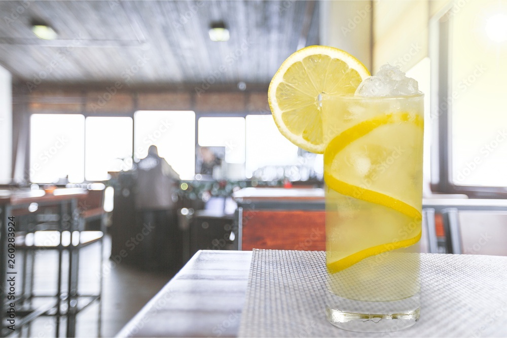 Lemonade with fresh lemon on  background