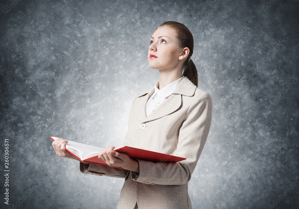 Attractive woman holding open notebook