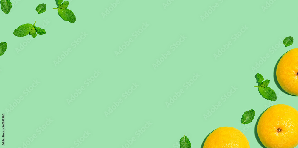 Fresh grapefruits on a bright color background