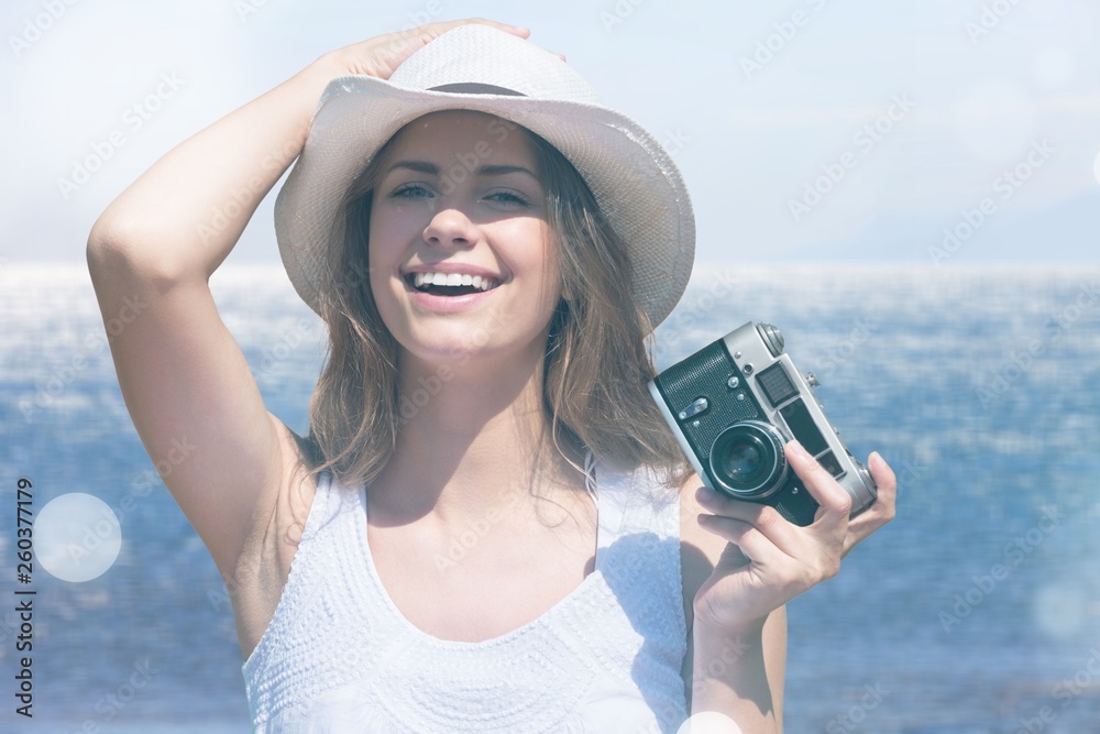 Outdoor summer portrait of pretty young smiling happy woman posing near the sea