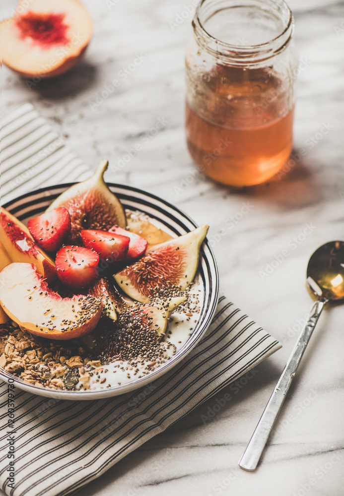 Healthy summer breakfast set. Greek yogurt granola bowl with strawberry, figs, peach, chia seeds and