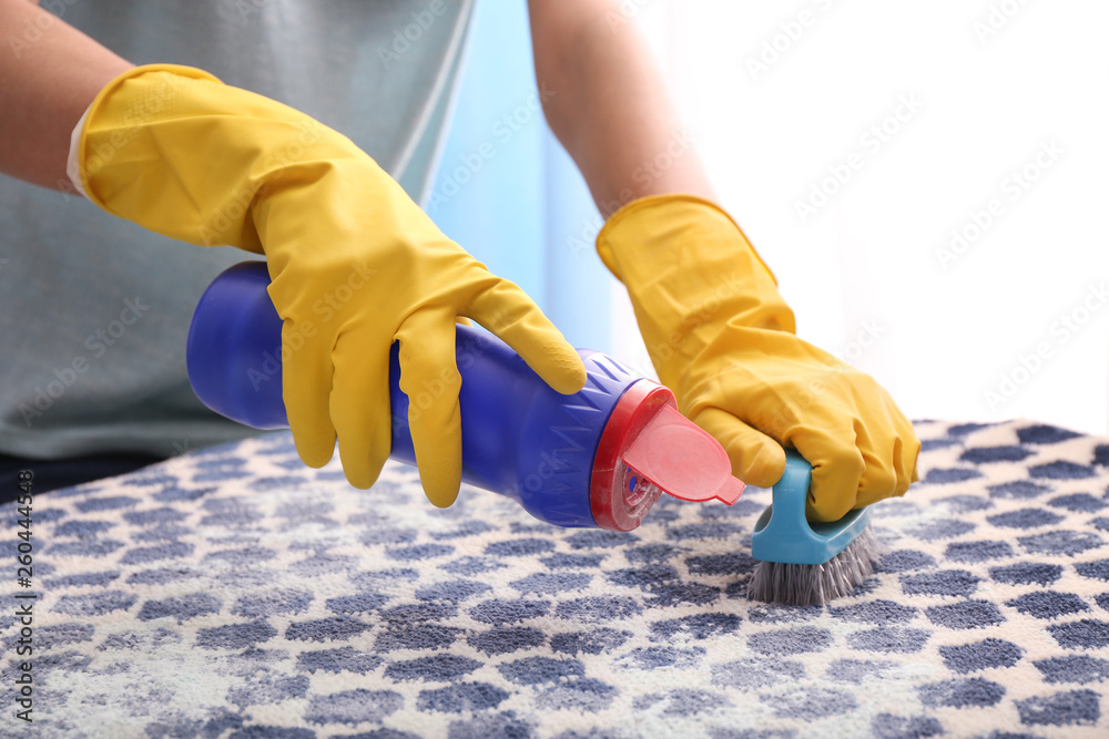 Woman cleaning carpet