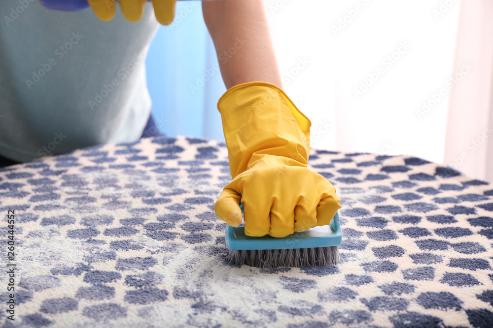 Woman cleaning carpet