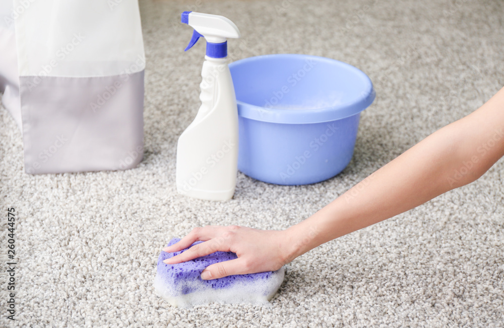 Woman cleaning carpet