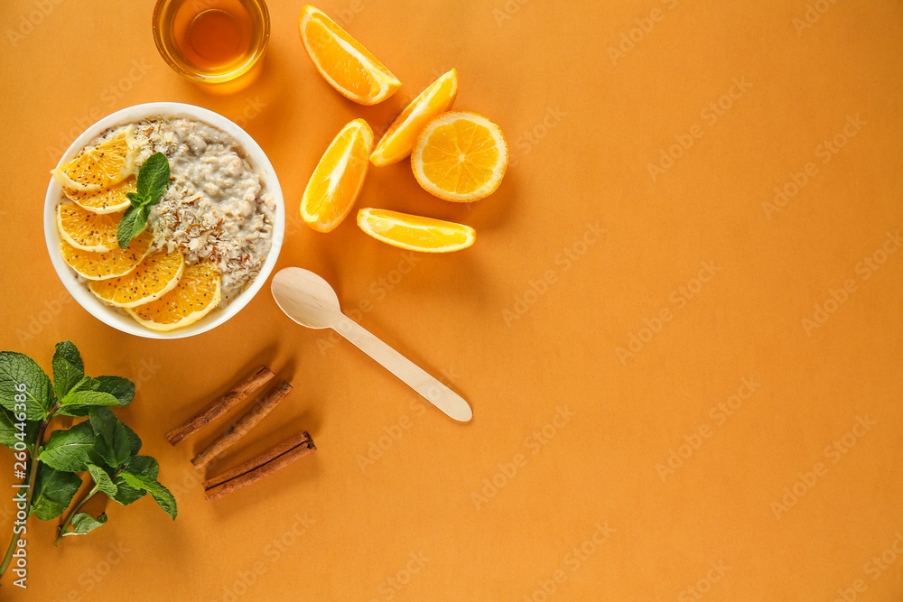 Bowl with tasty sweet oatmeal on color background