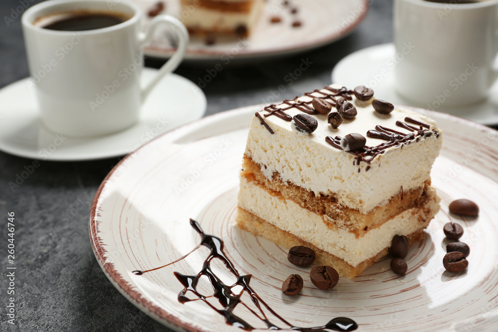 Plate with tasty tiramisu on grey table