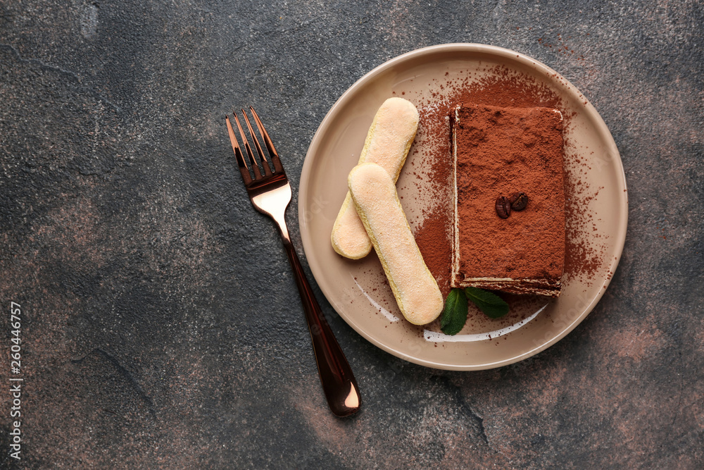 Plate with tasty tiramisu on grey table