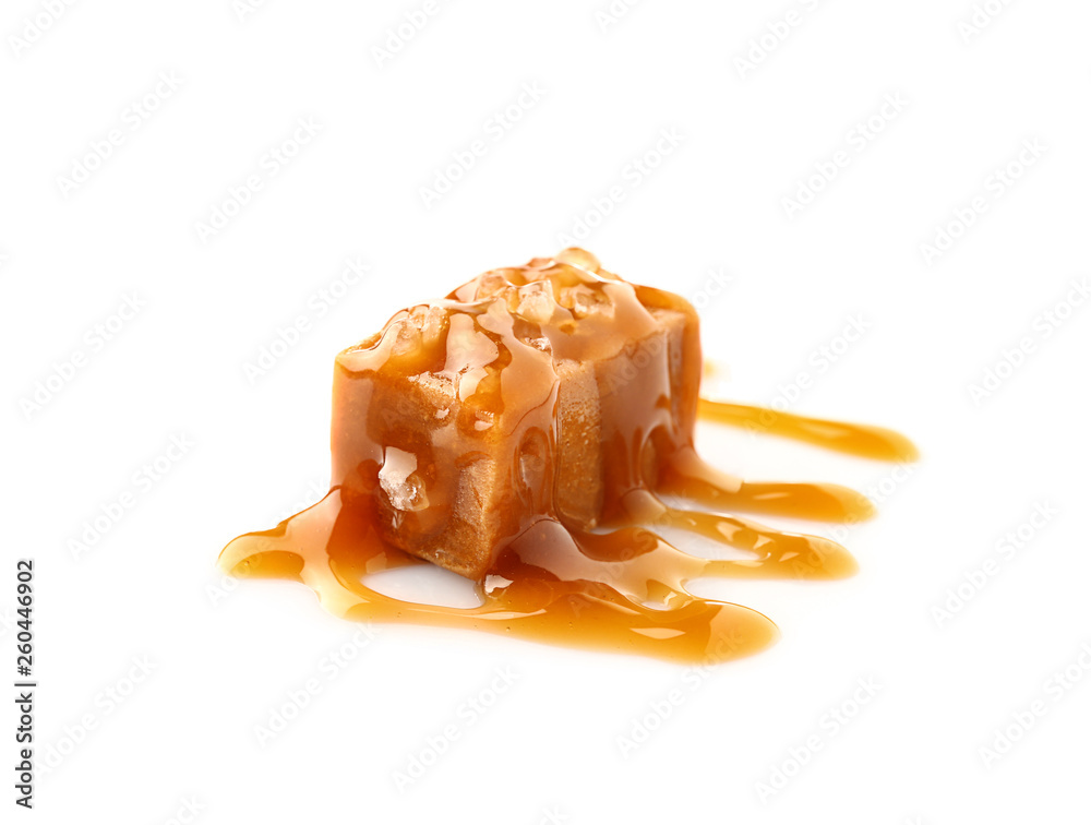 Tasty salty caramel candy on white background