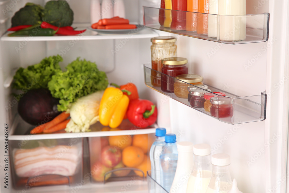 Open fridge full of different food