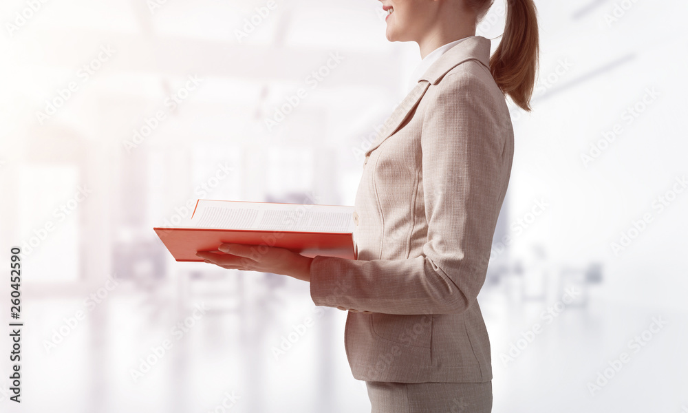 Businesswoman holding open notebook