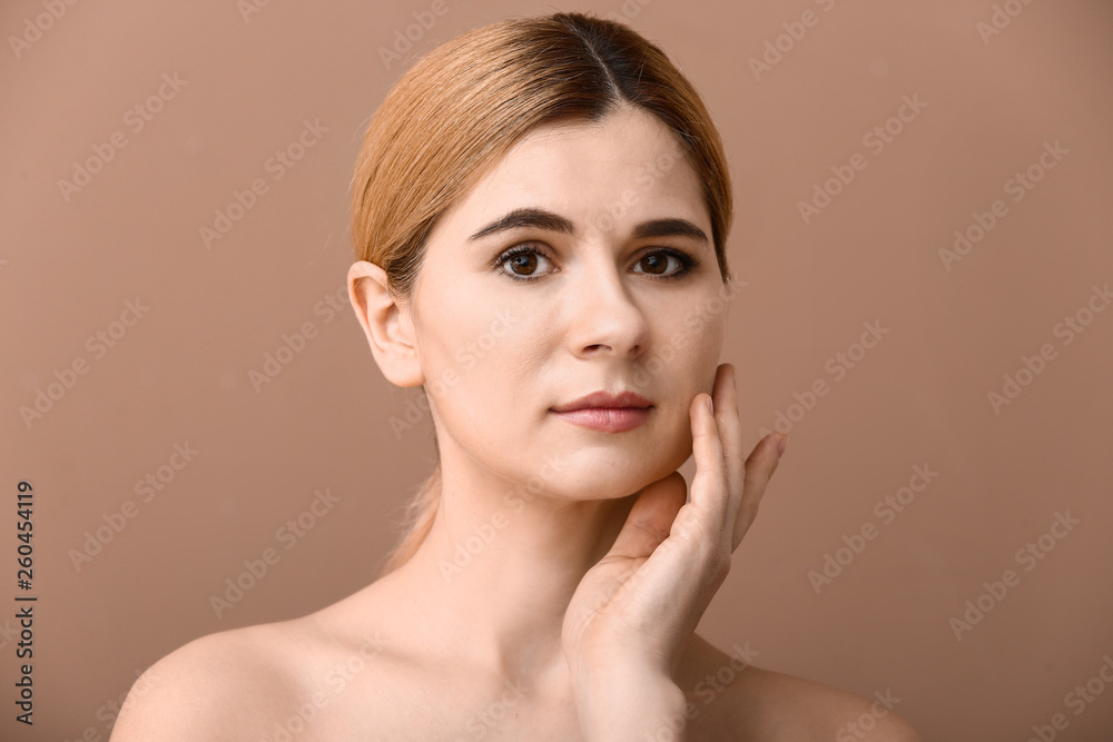 Portrait of beautiful woman on color background