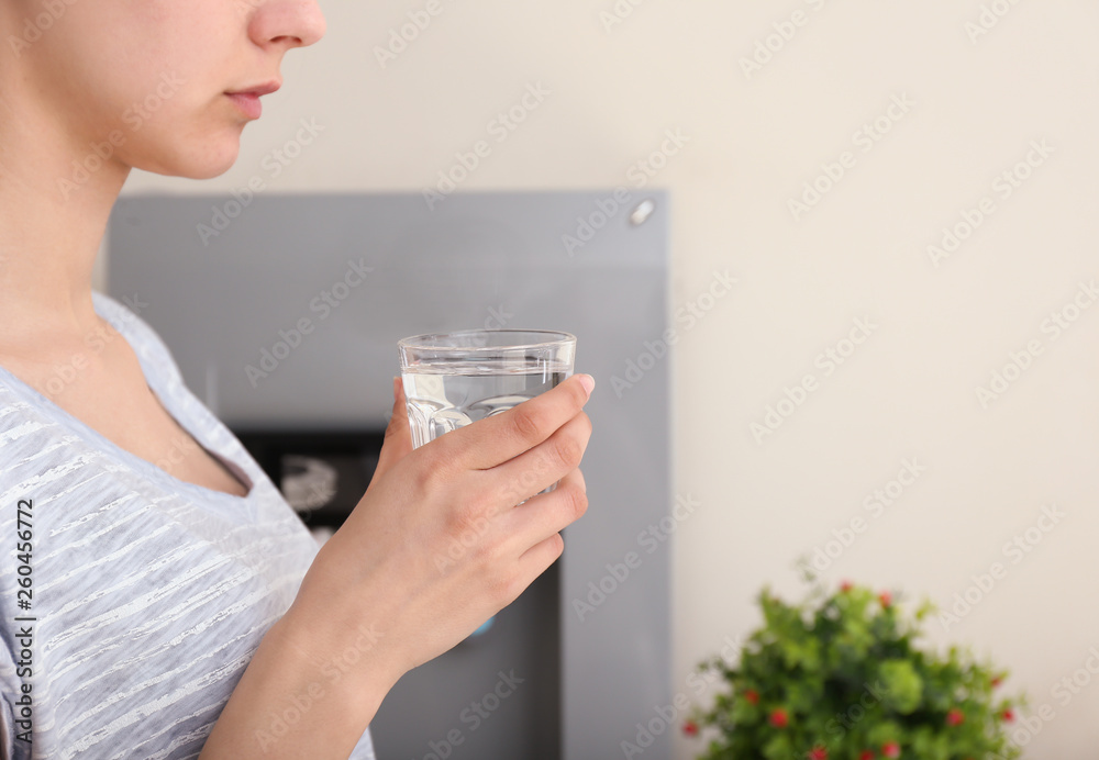 Woman with glass of water indoors