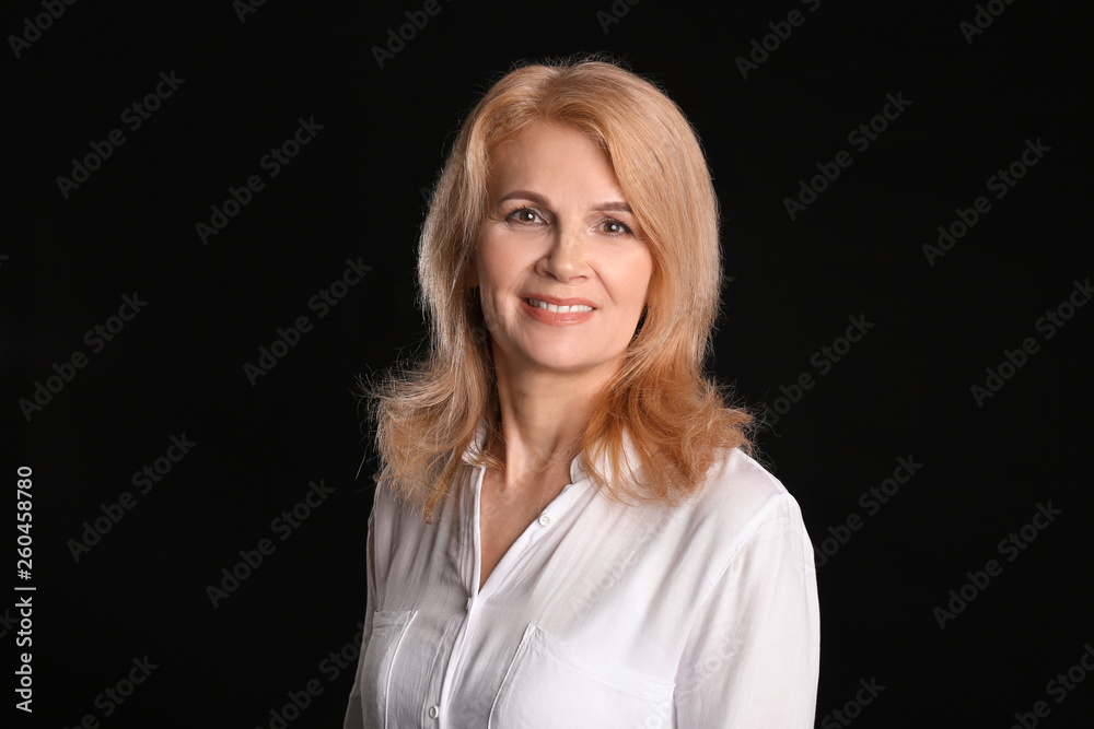 Stylish mature woman on dark background