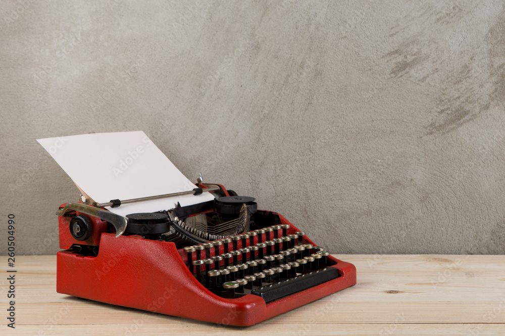 vintage typewriter on the table with blank paper - concept for writing, journalism, blogging